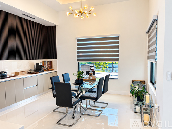 A modern dining room with a glass table and chairs.