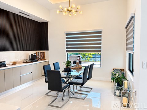 A modern dining room with a glass table and chairs.
