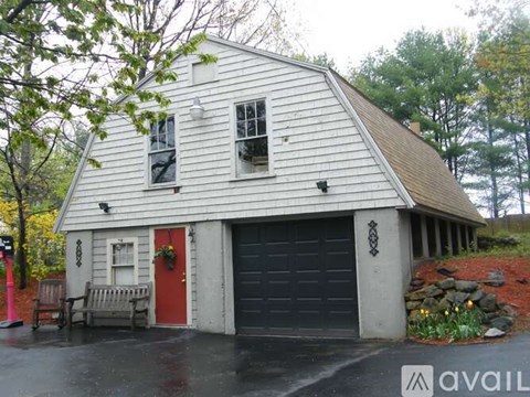 A house with a red door and a garage door.