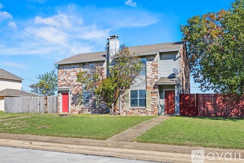 A house with a red door is for sale.