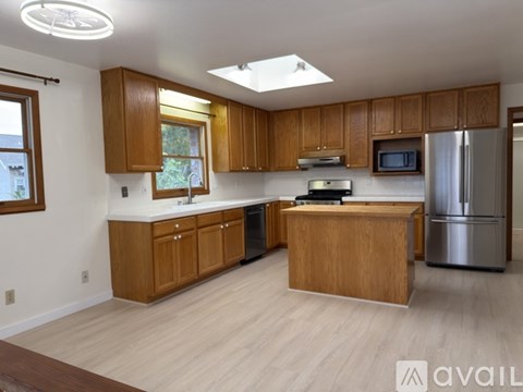 A kitchen with wooden cabinets and stainless steel appliances.