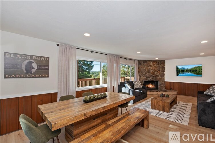 A modern living room with a wooden table and a fireplace.