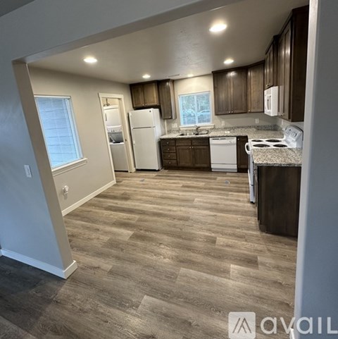 A kitchen with wooden cabinets and a white fridge.