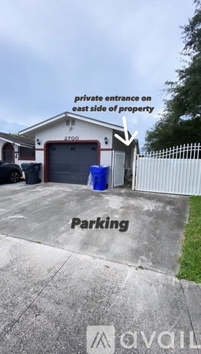 A parking area with a sign indicating a private entrance on the east side of the property.