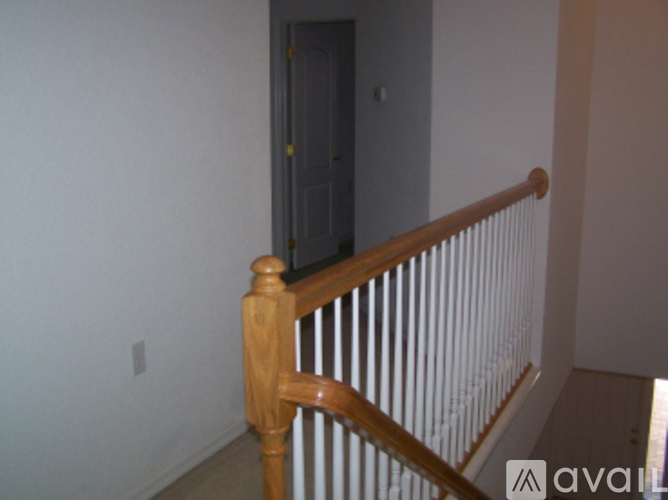 A wooden staircase with a white railing.