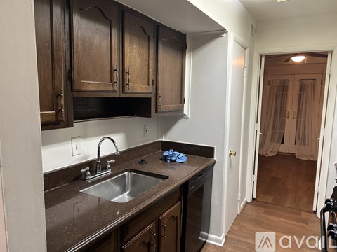A kitchen with brown cabinets and a white refrigerator.