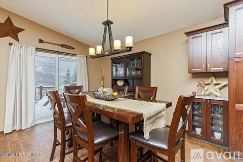 A dining room with a table set for four.