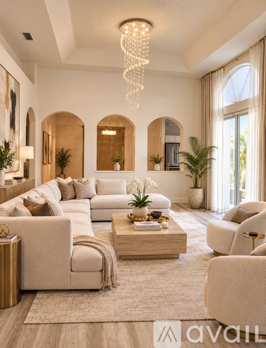 A modern living room with a large chandelier and a white sofa.