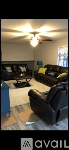 A living room with a ceiling fan and a couch.