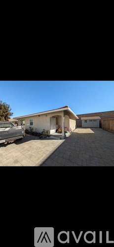 A house with a car parked in front.
