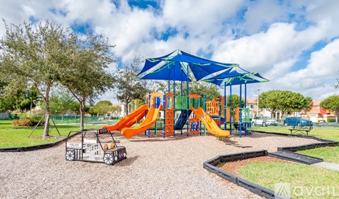 A playground with a blue canopy and a yellow slide.