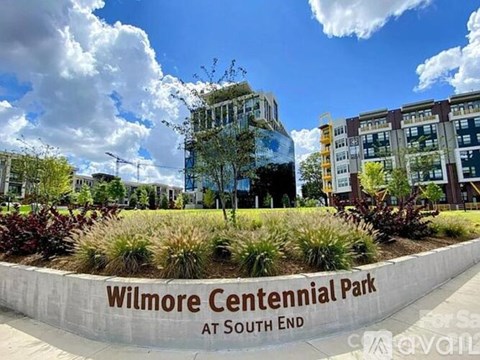 A sign in front of a building that says Wilmore Centennial Park at South End.