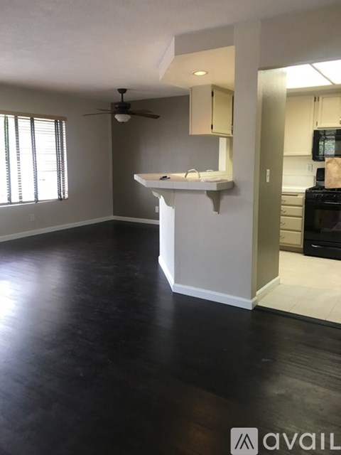 A kitchen area with a counter and a fan.