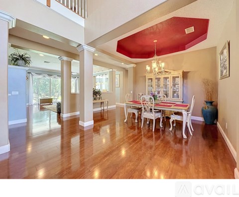 A dining room with a wooden table and chairs.