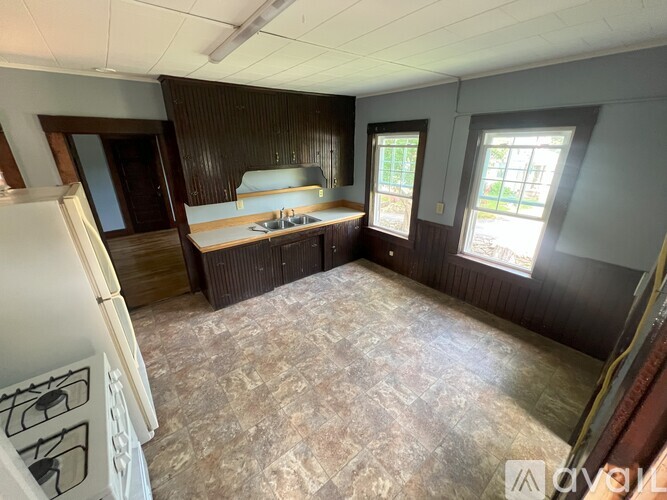A room with a kitchenette and a window.