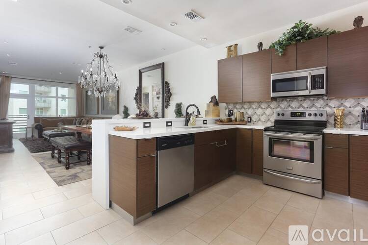 A modern kitchen with a large island and stainless steel appliances.