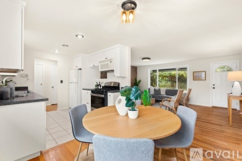 A modern kitchen with a dining table and chairs.