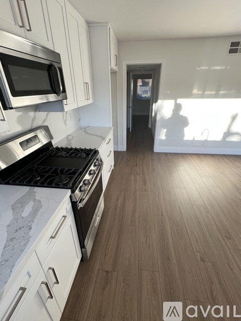 A kitchen with a stove top oven and microwave.
