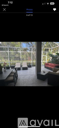 A modern dining area with a glass wall overlooking a garden.