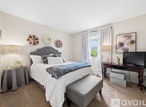A bedroom with a large bed and a television.