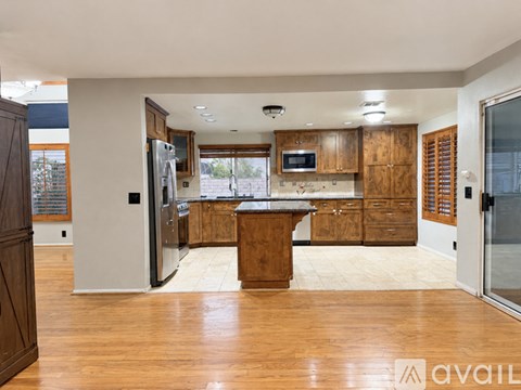 A kitchen with wooden cabinets and a central island.