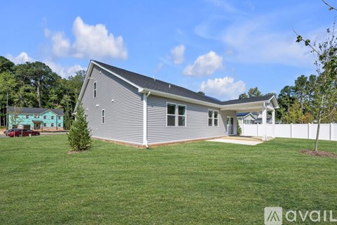 A house with a grey exterior is available for sale.