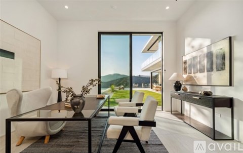 A modern dining room with a glass table and chairs.