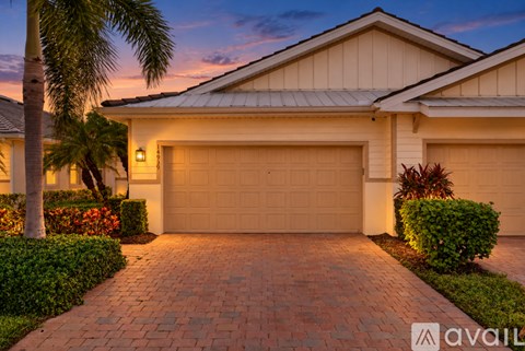 A house with a driveway and garage doors.
