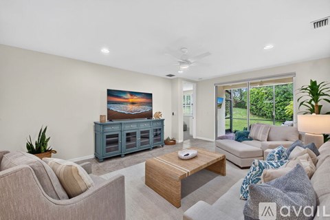 A living room with a grey couch, a wooden coffee table, and a painting on the wall.