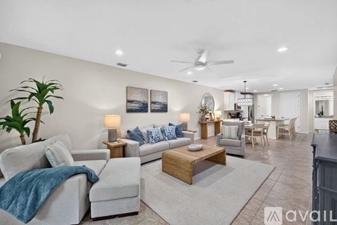 A living room with a couch, chairs, and a coffee table.