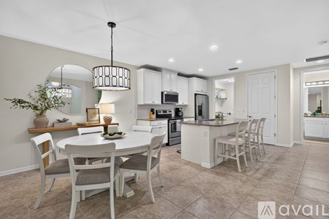 A modern kitchen with a dining table set for four.