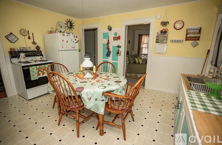 A kitchen with a table set for four and a sink to the right.