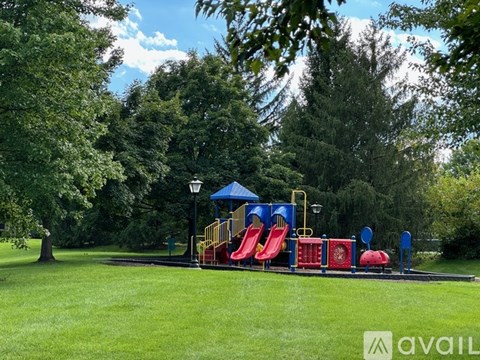 A playground with a blue canopy and red slide.