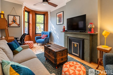 A living room with a grey couch and a blue chair.