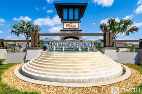 A pool with steps leading up to a building with a sign that says "Summerstone".