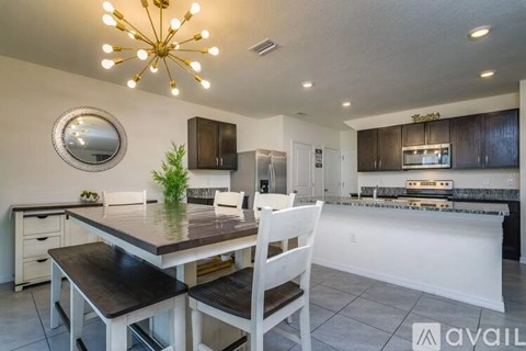 A modern kitchen with a dining table and chairs.