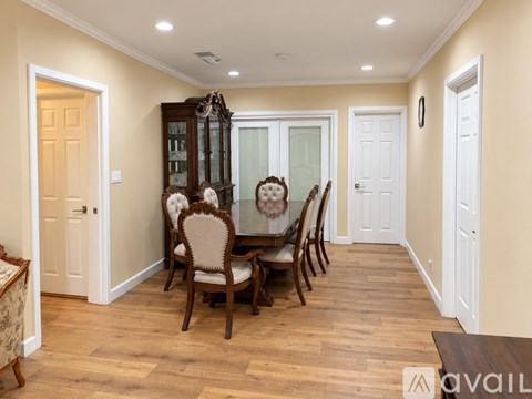 A dining room with a wooden table and chairs.