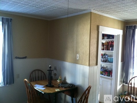 A dining room with a table set for two.