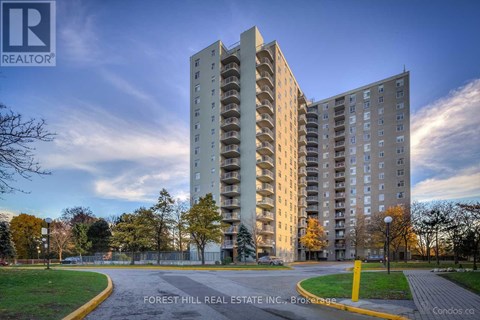 A tall apartment building with a sign that says Forest Hill Real Estate Inc.