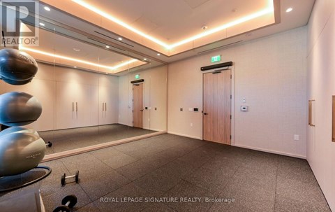 A spacious room with a treadmill and exercise equipment.