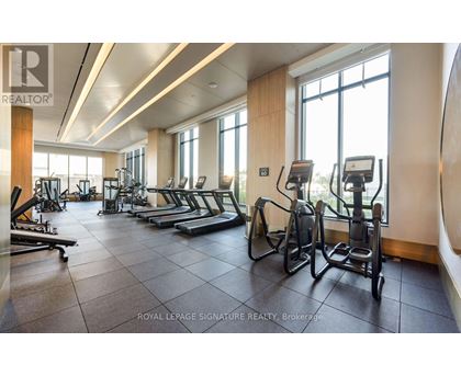 A gym with treadmills, elliptical machines, and other exercise equipment.