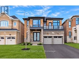 A large, modern house with a driveway in front.