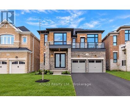 A large, modern house with a driveway in front.