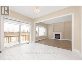 A spacious living room with a fireplace and sliding glass doors.