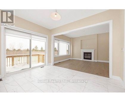 A spacious living room with a fireplace and sliding glass doors.