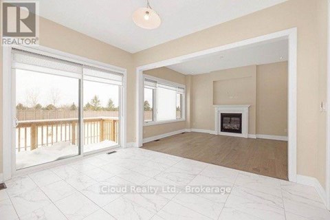 A spacious living room with a fireplace and sliding glass doors.