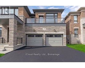 A modern house with a stone facade and a glass entrance.