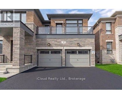 A modern house with a stone facade and a glass entrance.