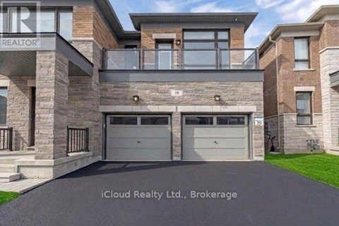 A modern house with a stone facade and a glass entrance.