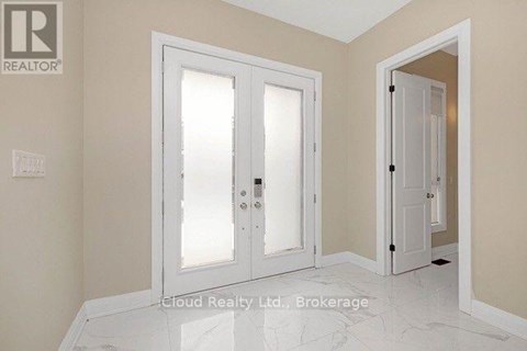 A white door with a glass panel is in a room with a marble floor.